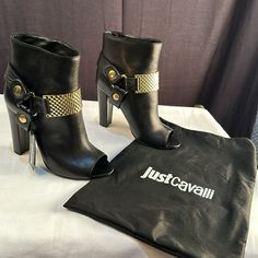 Kill Any Catwalk (Or Side Walk) In The Fierce Just Cavalli Peep Toe Bootie With Gold Hardware. Open Toe, Ankle Boot. Smooth Leather Upper With Gold-Tone Buckle And Harness. Bootie Boasts Chunky Heel For Stability And Style. Pull On Construction. Soft Leather Lining. Lightly Padded Leather Insole. Smooth Synthetic Sole. Wrapped Heel. Made In Italy. Heel Height: Approx 4" Side Walk, Wrap Heels, Just Cavalli, Chunky Heel, Chunky Heels, Smooth Leather, Gold Hardware, Bootie, Walk In