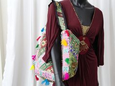 Patchwork, embroidery and sequins women's tote bag. A colourful ethnic shoulder bag from India for women. Unique, classy day or evening hand bag. Take patches of colourful cloth. Add interesting embroidery of sequins and stones and beads. Add some more colourful stitches with contrasting colour thread. Mix and match the patches and hand stitch them with a colourful beading. Add handles. Voila! You have a tote bag that is so unique that there just cannot be another one such, anywhere in the unive Bohemian Party Bags For Festive Season, Bohemian Multicolor Potli Bag For Party, Rectangular Multicolor Sequined Shoulder Bag, Bollywood Style Shoulder Bag For Festivals, Bohemian Shoulder Bag With Zari Work For Festive Occasions, Bohemian Multicolor Bags With Zari Work, Bollywood Embroidered Shoulder Bag For Festivals, Bohemian Multicolor Zari Work Bag, Bohemian Embellished Bag For Festive Occasions