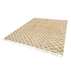 a beige and white checkered rug with fringes