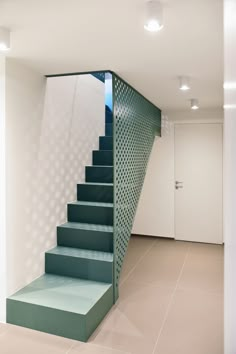 there is a set of stairs in the room with white walls and tile flooring