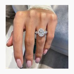 a woman's hand with a diamond ring on it