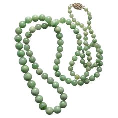 Bright, and filled with light, this radiant Art Deco era (circa 1920s -1930s) necklace is composed of 107 hand-carved and polished natural and untreated Burmese jadeite jade beads. The beads range in size from 4.13mm to 9.38. Overall, the beads are a bright, fresh spring green. I would say "pea green" but that sounds so awful. In truth, the beads are the color of those hard and shiny peas that you see when you crack open the first pod of the season. But these beads are also genetically gifted: t Jade Necklace Layering, 1930s Necklace, 1920s Jewelry, Necklaces Beaded, Jade Bead Necklace, 1st Dibs, Antique Costume Jewelry, Vintage Beads Necklace, Jade Necklace