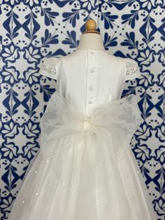 A delicate and traditional first communion gown for girls, it is made with lightweight organza in off-white. It has beautiful details throughout the dress. It has buttons on the back for closure and a bow. Dry clean Made in Spain Final sale, no exchanges nor returns are available Elegant Organza Dress For First Communion, Fitted Princess Dress With Bow For First Communion, Elegant White Ball Gown For First Communion, Fitted Organza Princess Dress For First Communion, Elegant Organza Princess Dress For Confirmation, Fitted Organza Ball Gown For First Communion, Elegant Tulle First Communion Dress, Fitted Dress With Bow For Confirmation, Organza Ball Gown For Baptism