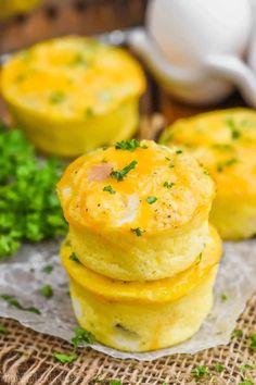 three mini cornbread muffins stacked on top of each other with parsley