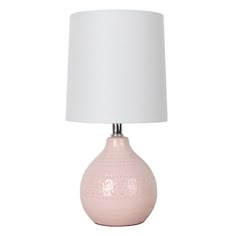 a pink ceramic table lamp with a white shade on the base and a white fabric lampshade