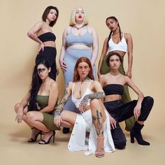 six women in different outfits posing for a photo