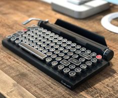 an old typewriter sitting on top of a wooden table