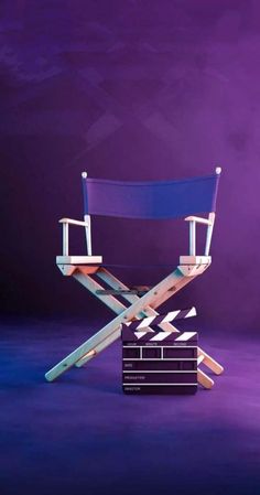 a blue director's chair sitting in front of a purple background