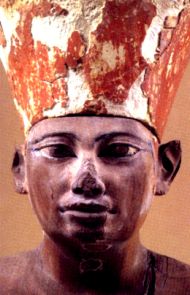 an ancient egyptian statue wearing a headdress