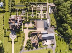 an aerial view of a large estate with lots of trees and grass in the foreground