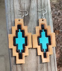 These hand tooled and hand painted leather earrings are a must for any southwestern outfit! They are the perfect size measuring 3 1/2 inches drop length and are lightweight. With a silver plated hook. Handmade Southwestern Leather Earrings, Southwestern Hand Tooled Leather Jewelry, Southwestern Hand-tooled Leather Jewelry, Tooled Earrings, Painted Leather Earrings, Southwestern Outfits, Tooled Leather Earrings, Custom Leather Work, Aztec Earrings