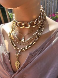 This handmade 24 K gold  plated chain layered multi stand stacked punk goth edgy style necklace set is a stunning piece of jewelry that is perfect for those who love bold and edgy accessories. This is two necklaces, the big chunky choker that is adjustable with a built-in extender from 14" to 17", and the 4-strand drop festoon design necklace (also adjustable 15" to 18"). Adding depth and dimension to the piece is a u lock and spearhead pendant. Very punk, grunge aesthetic! This necklace set is Multi Chain Choker Necklace With Cross, Luxury Double Chain Multi-strand Necklace, Punk Style Gold Jewelry With Adjustable Chain, Gold Punk Jewelry With Adjustable Chain, Trendy Multi-strand Chunky Chain Jewelry, Gold Punk Necklace With Adjustable Chain, Punk Gold Chain Jewelry, Punk Gold Choker Jewelry, Gold Punk Style Choker Jewelry