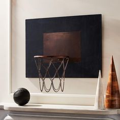 a basketball is in front of a basket on the wall next to a fireplace mantel