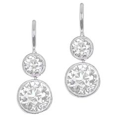 Discover understated elegance with these diamond earrings, showcasing bezel-set old European cut diamonds. The lower diamonds, weighing 1.88 carats combined, exhibit K color and VS2 clarity. Above, smaller diamonds weighing 0.63 carats combined add a touch of brilliance. Handcrafted in platinum, these earrings boast Euro-backs for a seamless fit. The measurements of the bottom diamonds are approximately 5.8mm x 5.8mm. Clarity: VS2 Color: K Color Material: Platinum Stone: Diamond Stone Cut: Old E Platinum Diamond Earrings With Rose Cut Diamonds, Platinum Diamond Earrings With Rose Cut, Platinum Rose Cut Diamond Earrings, Classic White Diamond Earrings With Rose Cut, Classic Platinum Rose Cut Diamond Earrings, Classic Sterling Silver Rose Cut Diamond Earrings, Classic Platinum Earrings With Rose Cut Diamonds, Classic Diamond Earrings With Bezel Setting, Classic Rose Cut Diamond White Earrings