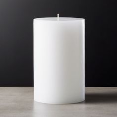 a white candle sitting on top of a table