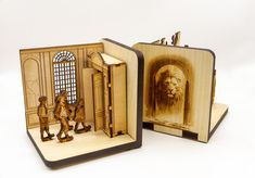 an open book with two figurines in it