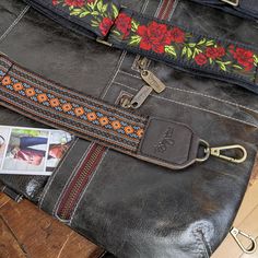 Our leather trimmed guitar-style handbag straps will instantly add personality to your favorite bag. Made with a variety of fun-colored woven prints and completely backed with high quality leather, this long adjustable 2 inch wide strap will transform the look of your Brynn Capella handbag, as long as it has d-rings to attach to. The durable leather based wide strap makes any bag super comfortable and stylish. Get more compliments than you ever imagined. Brown/Orange/Blue woven ribbon graphic di