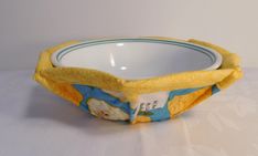 a yellow and blue bowl sitting on top of a table