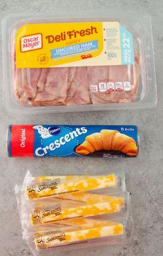 packaged food items displayed in plastic containers on counter top, including bread and cheese sticks