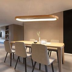 a dining room table with four chairs and a light fixture hanging over it's head