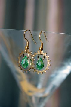 Steampunk brass gears and green glass drops by DevilsJewel on Etsy, $25.00 Steampunk Jewelry Earrings, Handmade Steampunk Gold Jewelry, Handmade Gold Steampunk Earrings, Steampunk Metal Jewelry Vintage Collection, Steampunk Metal Jewelry With Vintage Charm, Diy Armband