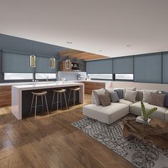 a living room filled with furniture next to a kitchen and dining area on top of a hard wood floor