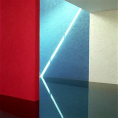 an abstract painting with red, white and blue colors on the wall next to each other