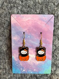 The cutest Halloween kitty earrings, she's sitting in a pumpkin in her Halloween costume. Cute Orange Halloween Earrings, Cute Orange Earrings For Halloween, Halloween Cat Ears Earrings For Pierced Ears, Halloween Cat Design Earrings With Cat Ears, Pumpkin Kitty, Halloween Kitty, Dangly Earrings, Cat Earrings, Halloween Cat