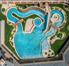 an aerial view of a swimming pool in the middle of a park