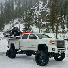 a white truck is parked in the snow