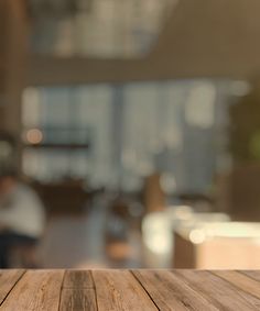 an empty wooden table with blurry background