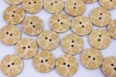 small wooden buttons with floral designs on them