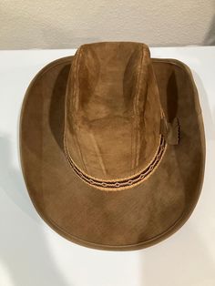 This vintage Stetson cowboy hat is a true gem for any Western enthusiast. Made in the USA with high-quality brown suede and a silk, lining, this hat is both stylish and durable. Perfect for men who want to add a touch of USA-themed flair to their wardrobe, this hat is sure to turn heads. The size 7-5/8 fits most head sizes, making it a versatile accessory for any occasion. Whether you're going for a classic cowboy look or simply want to add some unique style to your outfit, this Stetson hat is t Brown Leather Western Hat, Brown Western Felt Hat For Ranch, Western Leather Hat For Rodeo, Western Brown Hat Bands For Ranch, Western Brown Hat Bands For Rodeo, Classic Brown Felt Hat For Rodeo, Western Style Brown Hat Bands For Ranch, Classic Brown Fedora For Western-themed Events, Classic Brown Fedora For Western Style