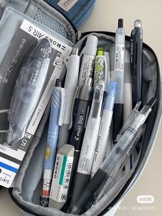 an open suitcase filled with pens and markers