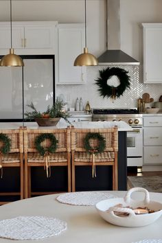 the kitchen is decorated for christmas with wreaths