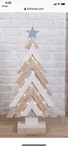 a wooden christmas tree with lights on it