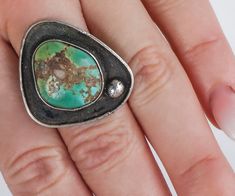 A great vintage bezel set turquoise ring with beautiful green hues. In very good vintage condition and would look great on any finger. Vintage Ring - Vintage Green Turquoise Sterling Silver Ring Sterling Silver Turquoise Ring Size 7.5 Ring measures approximately 1 1/4'' from top to bottom, back of band 3.97mm. Please read our shop policies prior to purchase. Thanks for looking and contact us with any questions. Vintage Oval Turquoise Ring, Antique Green Multi-stone Ring, Vintage Green Turquoise Cabochon Ring, Vintage Green Open Ring Jewelry, Vintage Multi-stone Green Emerald Ring, Vintage Green Emerald Ring With Multi-stone, Vintage Chrysoprase Ring Jewelry, Collectible Green Turquoise Ring, Vintage Green Turquoise Ring