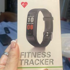 a person holding up a card with an image of a wrist and heart rate monitor on it