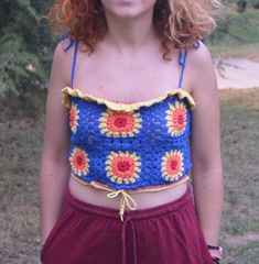 "The colors can be seen different according to your screen. - Boho hippie handmade crochet sunflowers on blue crop top. - This cotton tank top can be a favorite piece of your wardrobe this Summer. Handmade crochet top is perfect for summer party and beach outfit. - The crochet tops can easily be paired with jeans, denim shorts, mini skirts as well as they go beautifully with boho, soft fabric pants or long skirts - This crochet top handcrafted with 100% cotton thread of the best quality. - Available in all color; if you need your crochet top to be made in another color please just drop me a message, I will be happy to knit one for you. - This is a made to order crochet crop top, please allow sometime 8-12 days for preparation before shipment. - Hand knitted crochet crop top; vegan pullover Blue Cropped Crop Top For Festival, Handmade Blue Tops For Festival, Festival Crochet Blue Crop Top, Blue Crochet Crop Top For Festival, Blue Summer Crochet Top For Festivals, Hippie Sleeveless Crochet Crop Top, Blue Crochet Summer Crop Top, Blue Crochet Sleeveless Crop Top, Blue Crochet Crop Top For Summer