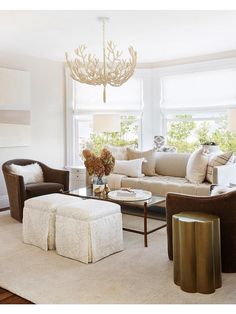 a living room filled with furniture and a chandelier