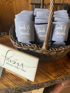 a basket filled with blue napkins sitting on top of a table next to a sign