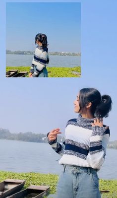 a woman standing on top of a grass covered field next to a body of water