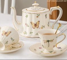 the tea set is decorated with butterflies on it