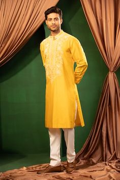 Yellow kurta with thread embroidery on front and piping detail on collar, cuffs. Paired with a white pant. - Aza Fashions Festive Cotton Sets With Tonal Embroidery, Festive Tonal Embroidery Sets For Eid, Festive Sets With Tonal Embroidery For Eid, Ceremonial Embroidered Cotton Sherwani, Festive Wedding Kurta With Tonal Embroidery, Festive Traditional Wear With Tonal Embroidery For Eid, Eid Festive Traditional Wear With Tonal Embroidery, Traditional Festive Embroidered Fabric With Tonal Embroidery, Eid Fitted Kurta With Tonal Embroidery