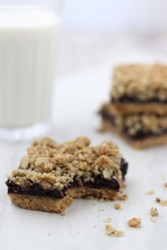 two pieces of food sitting on top of a table next to a glass of milk