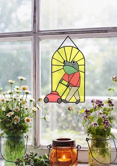 three vases filled with flowers sitting on top of a window sill