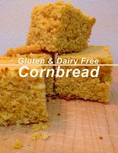 four pieces of cornbread sitting on top of a cutting board with the words gluten and dairy free cornbread