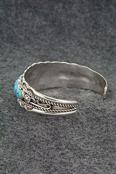 This stunning Kingman turquoise and sterling silver bracelet was made by Navajo silversmith Anthony Brown. The inside of the cuff is signed Anthony B and stamped sterling.Size: 5 1/2" (will fit up to a 6 3/4" wrist)Gap: 1 1/4"Width: 3/4"Free shipping on all orders! We ship with USPS and always include tracking. All orders ship within a day of payment.Returns are accepted up to 30 days after you receive your order. Just send us a message. Our shop offers cash back or store credit. The item must be returned in new condition. Anthony B, Kingman Turquoise, Sterling Silver Bracelet, Turquoise Sterling Silver, Sterling Silver Bracelets, Silver Bracelet, Gap, Cuff, Turquoise