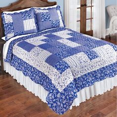 a blue and white quilted bed in a bedroom