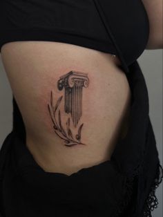 a woman's stomach with a tattoo on the side of her belly and an ancient greek column